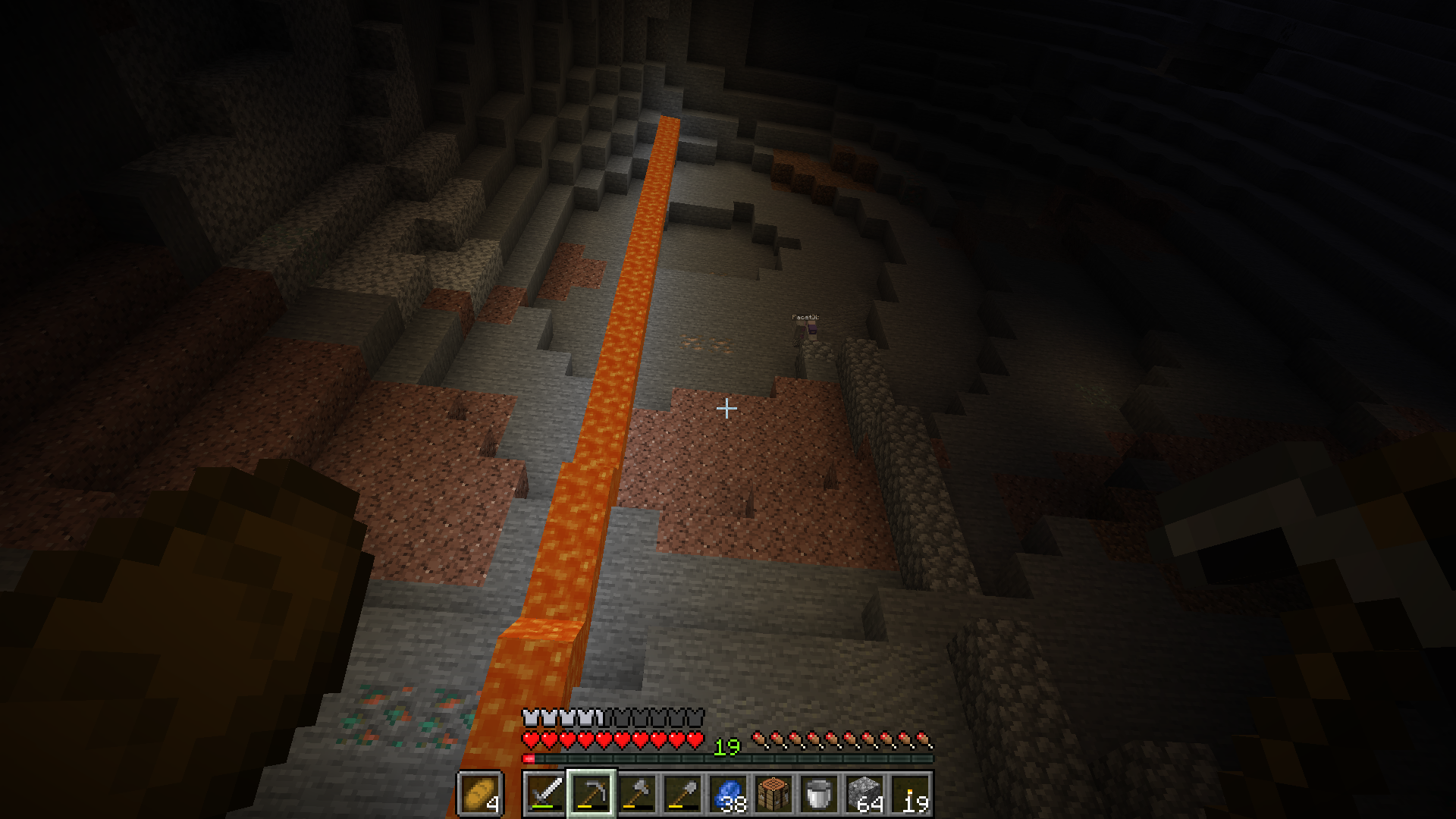 Ein Lavafall fließt von der Decke aus die Höhlenwand herunter. Alice baut sich einige Blöcke daneben mit Bruchsteinsäulen die Wand hoch.